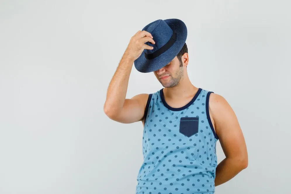 young-man-pulling-down-hat-eyes